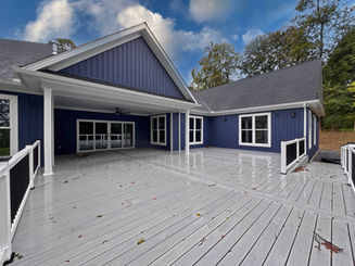 Oversized deck on home with blue siding