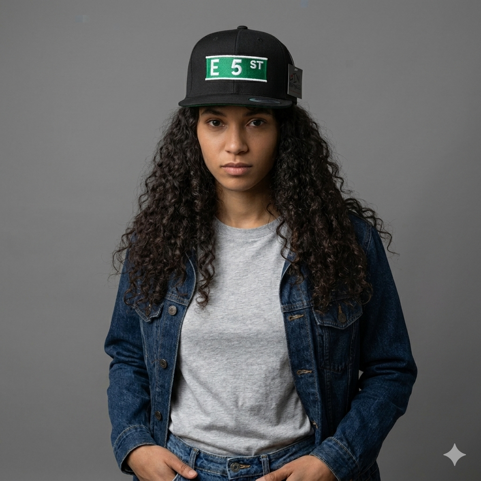 Woman wearing a black E 5th St hat and denim jacket.