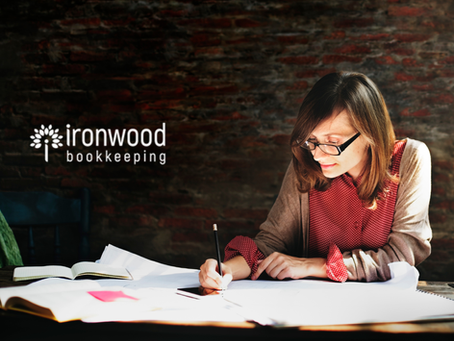 A woman working on accounts at her desk.