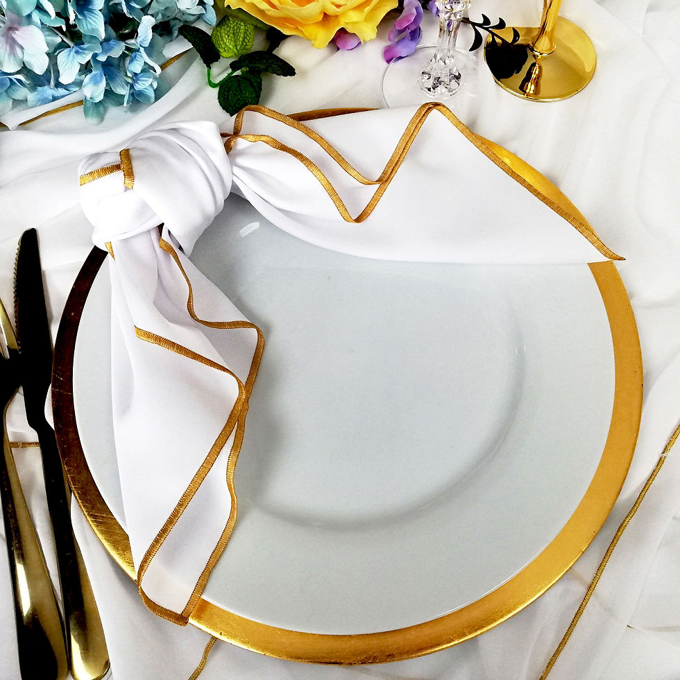 Thumbnail: a white napkin with gold trim on a white plate and gold charger tied nicely