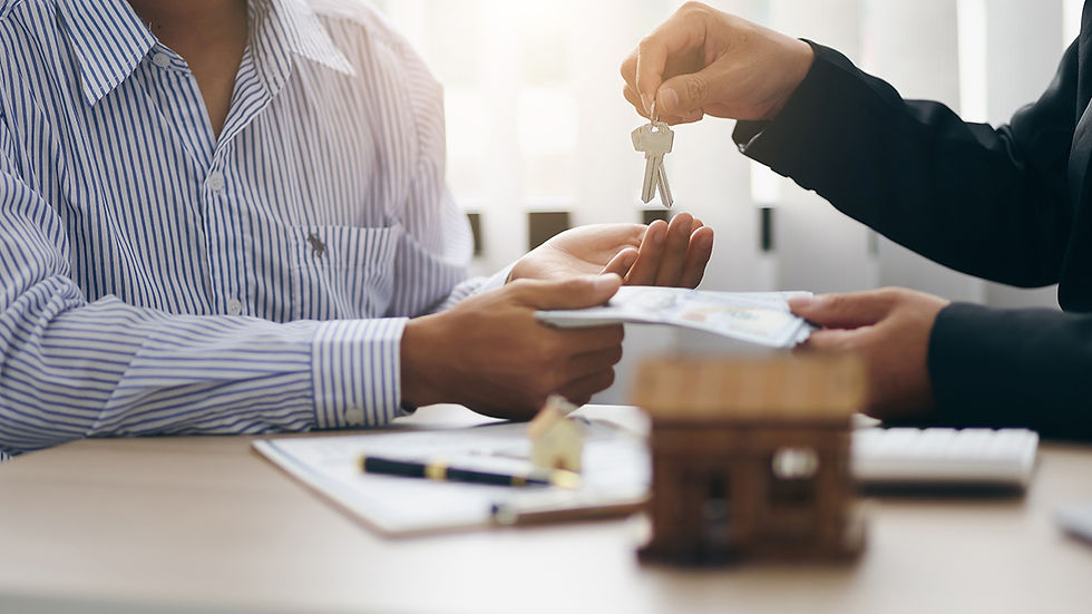 A property manager hands over keys to a new tenant, symbolizing the start of a successful rental agreement.
