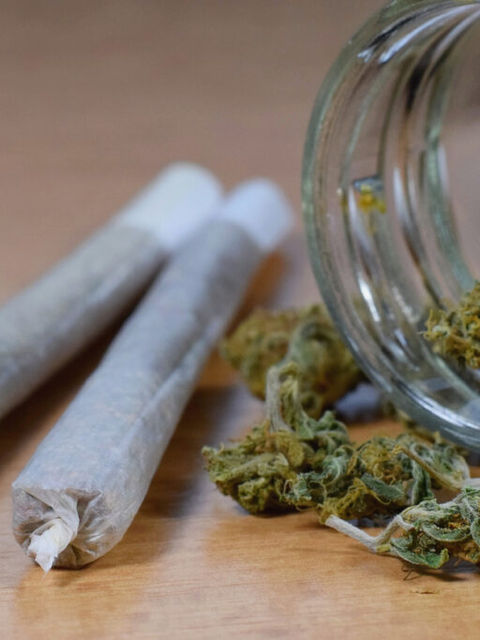 Marijuana buds jar and joints on the table