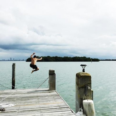 Hiro jumps - the island just off shore is a turkey vulture sanctuary