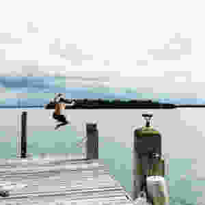 Hiro jumps - the island just off shore is a turkey vulture sanctuary