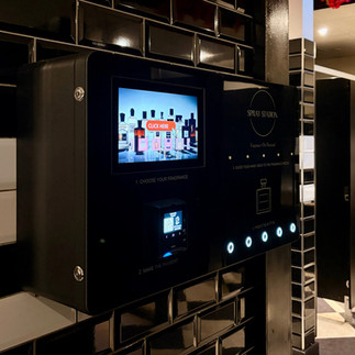 Spray Station wall-mounted perfume vending machine used in UK venues.