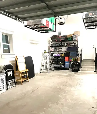 Organized garage with storage shelves, ladder, and various items home organization services in Clearwater, FL
