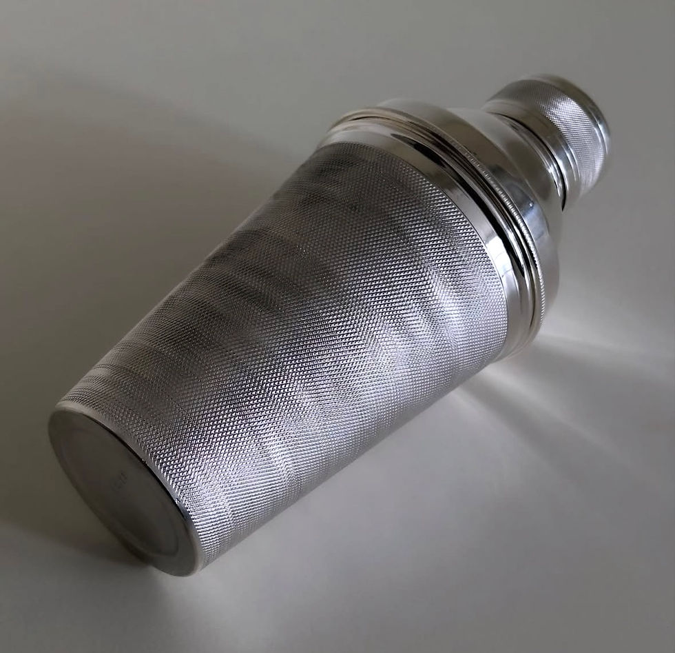 Thumbnail: A Deco Engine Turned Cocktail Shaker and Lemon Squeezer, c.1930