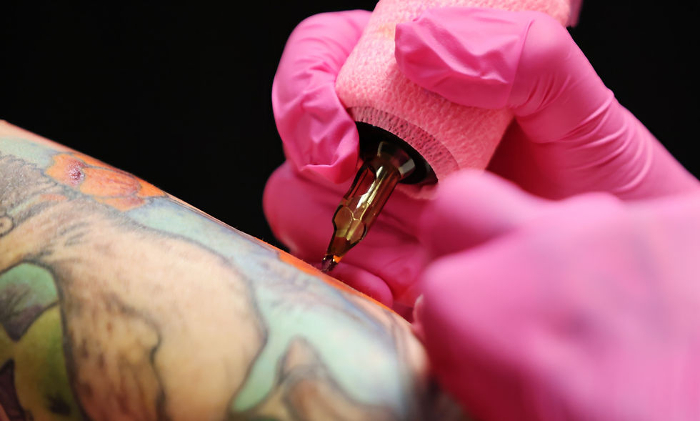 High angle view of a tattoo artist working on a geometric tattoo