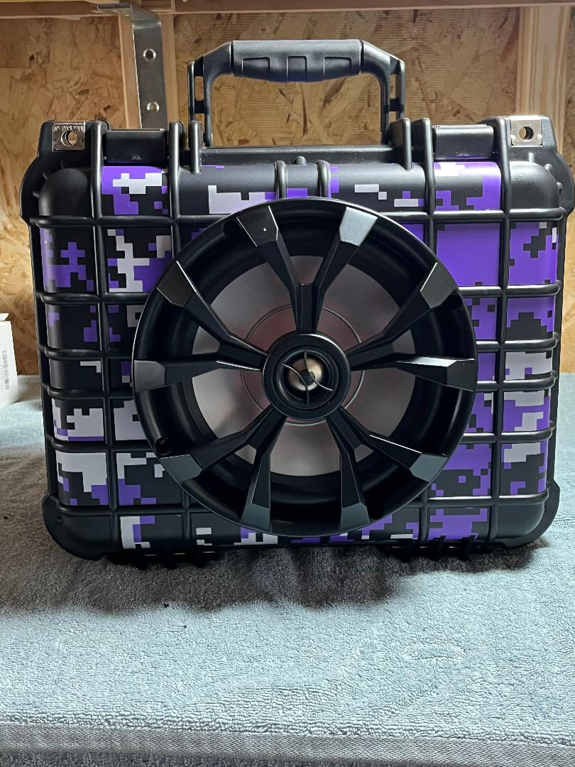 Close-up of rugged boombox speaker showing front grille and controls
