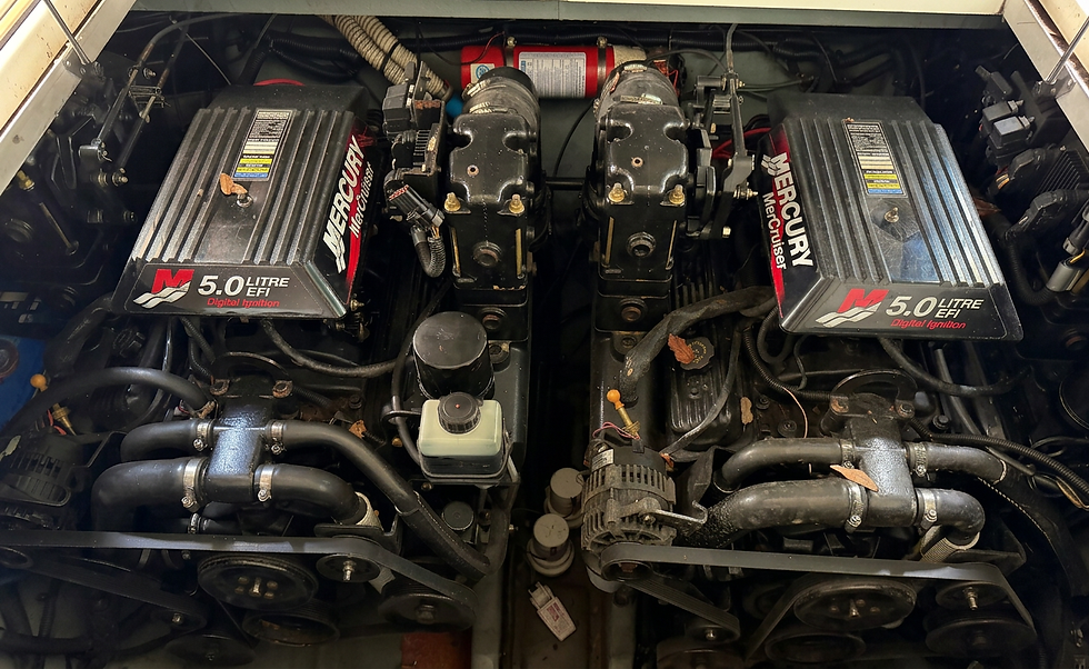 Mechanical detail shot of twin Mercury boat engines. The image showcases the complex engineering and parts of high-performance marine propulsion.