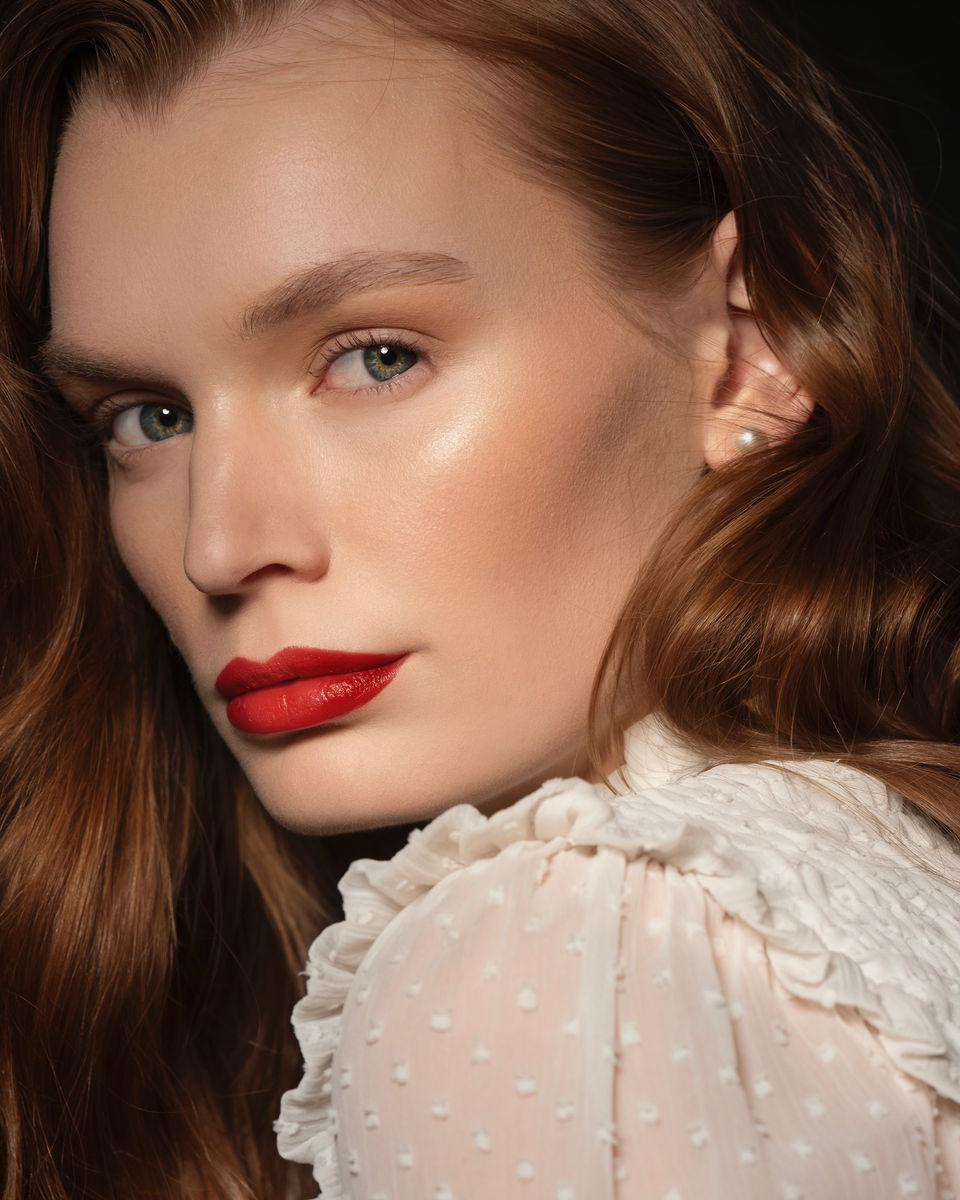 Beauty portrait of Anouk de Vries wearing minimal makeup and striking red lipstick