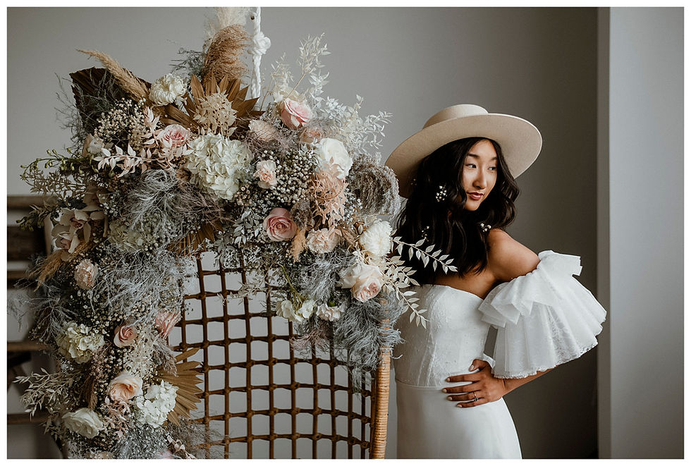 modern bohemian bride in hat with floral installation