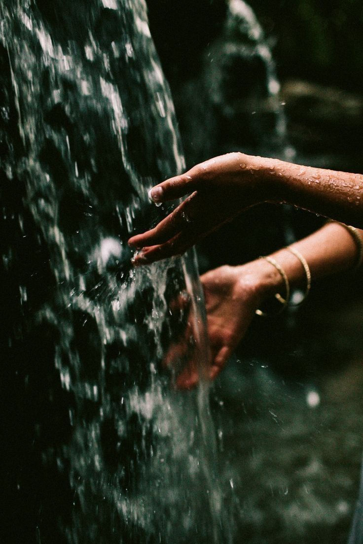 hands in waterfall, symbolizing receiving without guilt