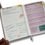 Thumbnail: A hand holding a book with handwritten notes and reflections, displaying various financial figures and contact information