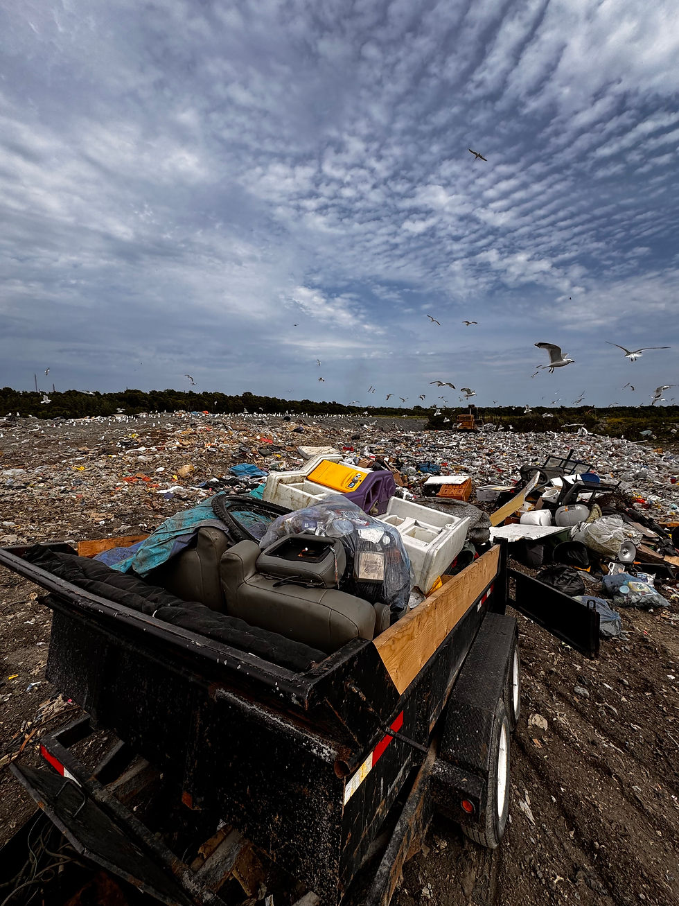 Dump trailer unloading garbage at dump