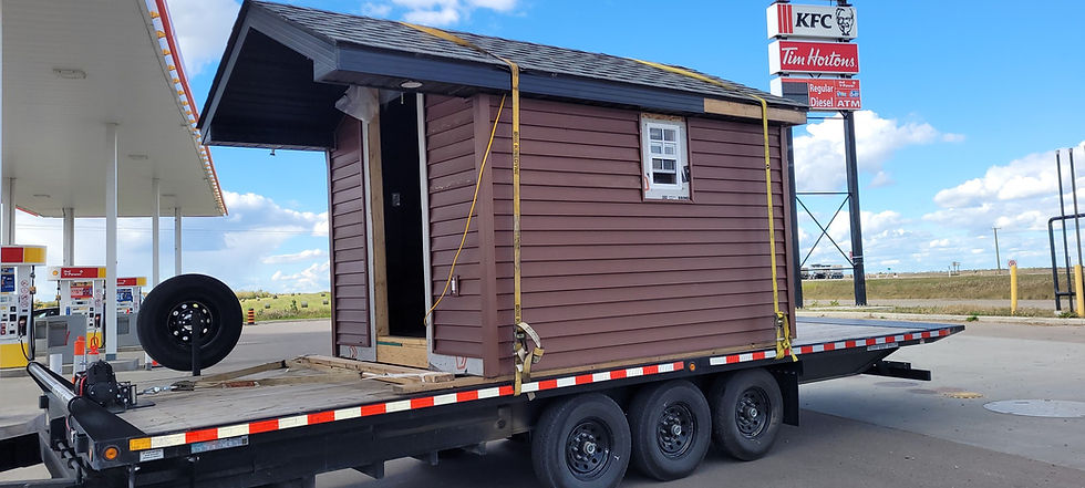AYMR Towing flatdeck truck transporting a storage shed in Parkland County.jpeg