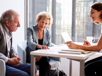 Travelers sit with their travel advisor to go over their travel plans
