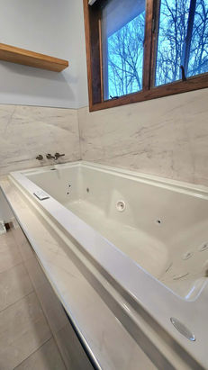 Crafted Shower Systems surrounds this new Jacuzzi Fuzion whirlpool creating a serene escape after this bathroom remodel