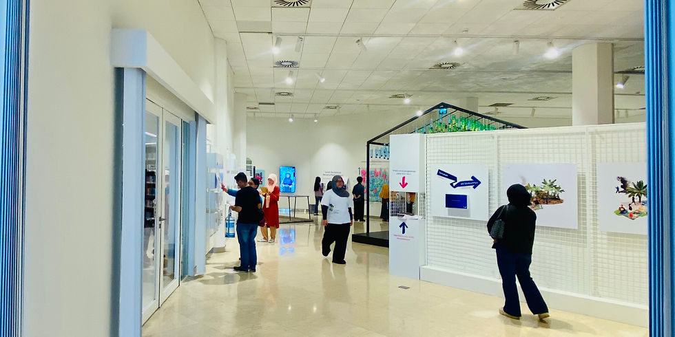 Visitors viewing art exhibits at Erasmus Huis Library