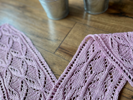 a pink lace scarf draped elegantly in front of some potted plants