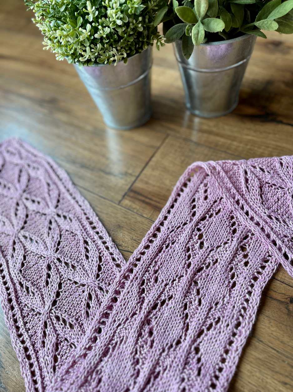 a pink lace scarf draped elegantly in front of some potted plants