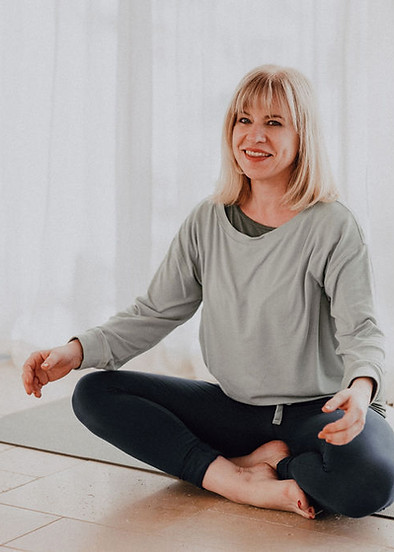 Liza in a Yoga Studio sat on the yoga mat in easy pose