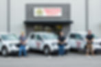 Amazing Floors Florida LLC staff standing in front of branded work trucks and showroom entrance, showcasing professional flooring services including tile, carpet, wood, and vinyl installation.