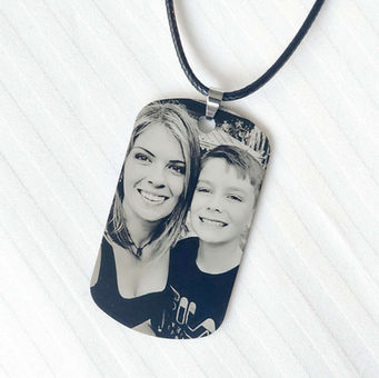 and photo engraved in black and white on a dogtag against a white background