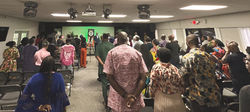 Faith community gathered for worship experience in modern worship space