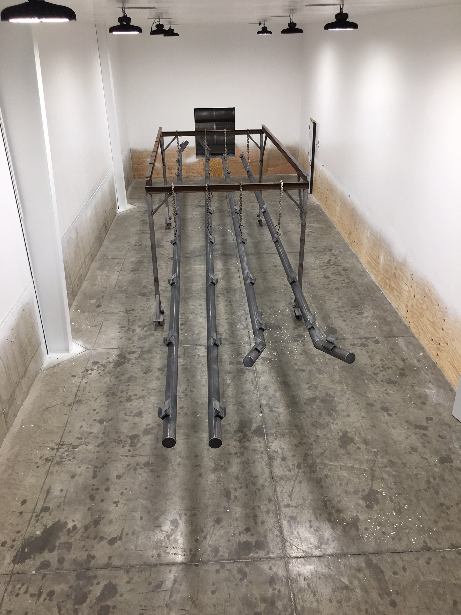 Poles ready for paint in booth