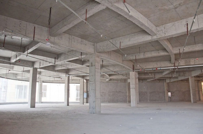 This image depicts a under construction room featuring concrete floors and ceilings, requiring professional construction takeoffs, quantity takeoffs, and material takeoffs.