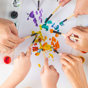 mothers-hands-with-children-hands-painting