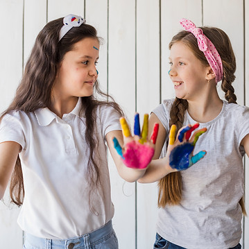 two-girls-showing-colorful-painted-hand
