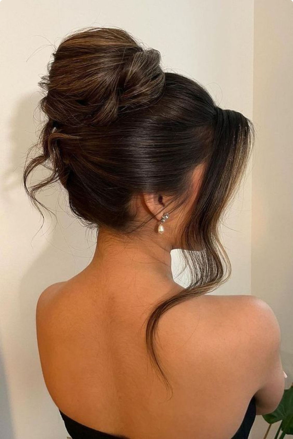 A soft, loose bridal updo on dark hair