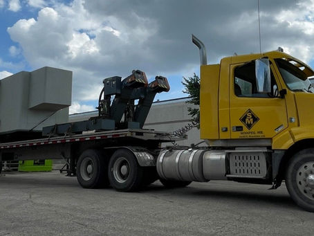 a trailer transporting heavy equipment