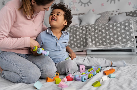 nanny lady playing with toys with a kid