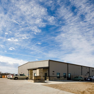 Wide exterior view of the American Mechanical Headquarters showing the office entrance integrated into the larger industrial facility.
