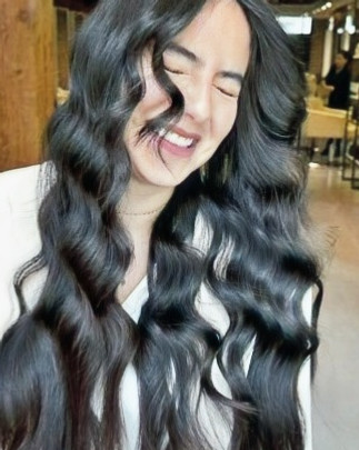 Client with long wavy hair at M Prive luxury hair salon in Gastown, Vancouver