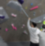 A climber brushing a hold before they climb