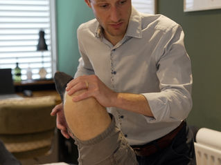 Advanced Physiotherapist assessing a patient considering hip replacement