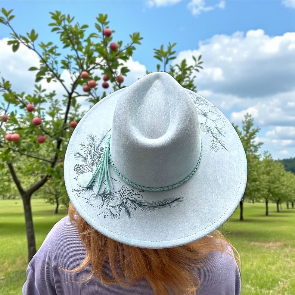 Blue felt wide brimmed hat  engraved with winter flowers modelled in orchard landscape