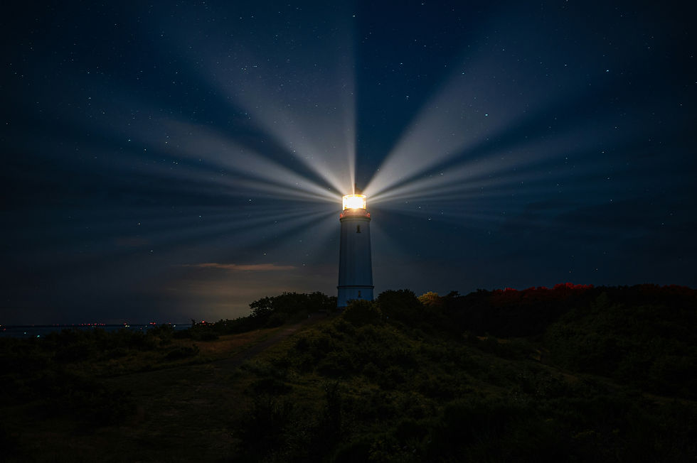 Lighthouse beams shining through the night sky.