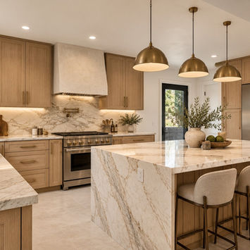 Kitchen remodel in Pacific Palisades with white oak cabinets, a marble waterfall island, brass pendant lights, and a plaster range hood, by Built To Perfection, Inc.