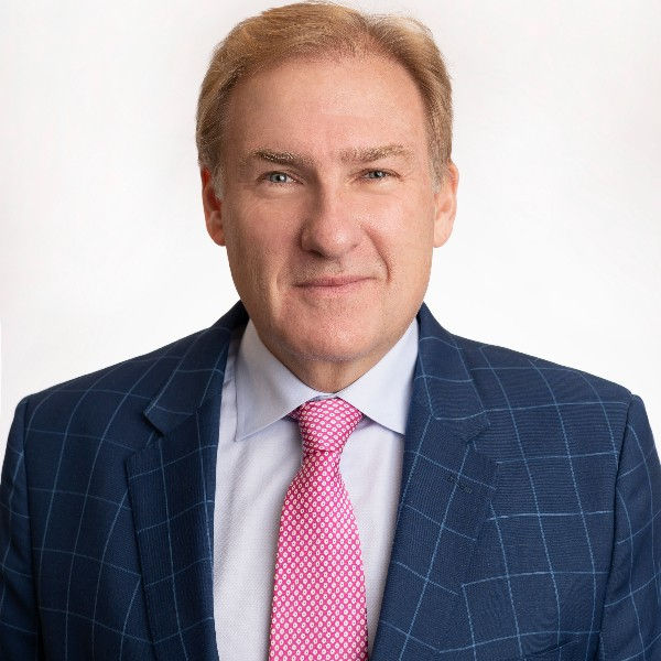 A headshot of Mark Murphy, a financial advisor and bestselling author, smiling confidently in a suit, featured in a podcast interview about wealth-building and entrepreneurship.