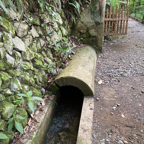 Stone waterway set into the hillside.