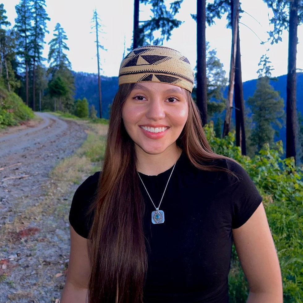 A photo of Jada smiling outside on a green path
