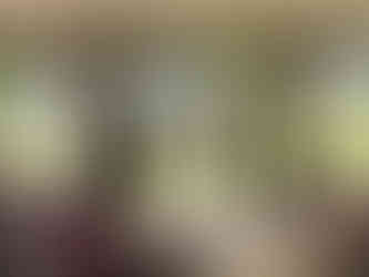 Will presents to the training participants who gather around circular tables, facing Will and another presenter holding a large note pad