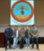 CNNCTS Panelists (from left to right) Henry Najera (Luiseño), Johnny Bear Contreras (Kumeyaay), Theresa Gregor (Kumeyaay/Yoeme), Megan Jennings (CNNCTS Principal Investigator and Panel Moderator), and Cliff Devers (Luiseño) stand together on the presentation stage in Montezuma Hall on campus at SDSU. The Native Resource Center logo is displayed on a projector screen behind them.