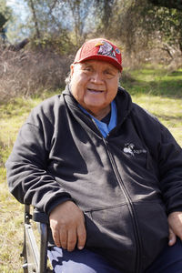 Ron Goode sits in a chair and smiles.