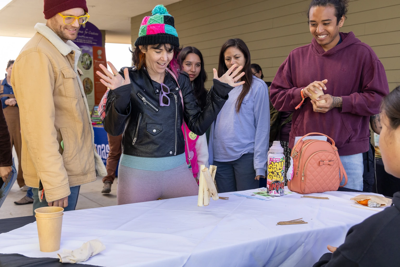 A person plays a game with sticks at a table